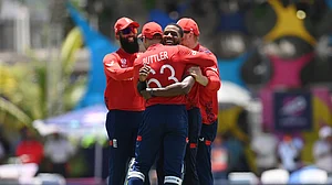 Jos Buttler and Chris Jordan celebrate the latter's hat-trick on Sunday.
