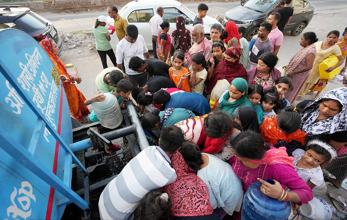 PTI : Residents gather around a tanker to collect water in Delhi amid crisis