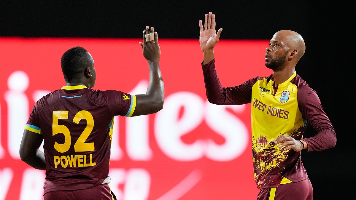AP Photo/Ricardo Mazalan : West Indies' Roston Chase, right, is congratulated by teammate Rovman Powell after dismissing United States' Aaron Jones during the men's T20 World Cup cricket match between the USA and the West Indies at Kensington Oval, Bridgetown, Barbados.