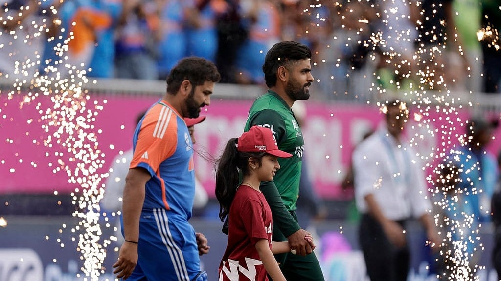AP/Adam Hunger : Pakistan's Babar Azam, right, and India's captain Rohit Sharma walk into the field before the start of the ICC Men's T20 World Cup cricket match between India and Pakistan at the Nassau County International Cricket Stadium in Westbury, New York, Sunday, June 9, 2024