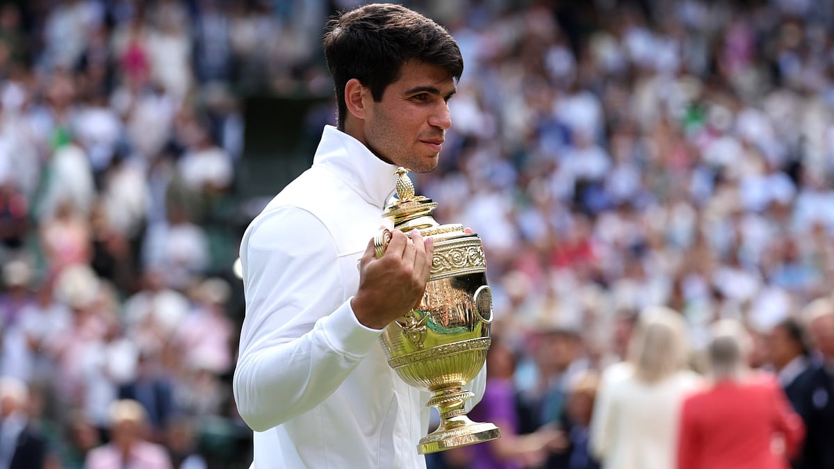 Carlos Alcaraz with the Wimbledon trophy. - null