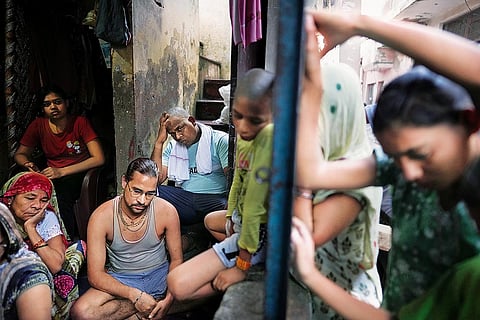 Family members and relatives of Asha Devi mourne at their familial home