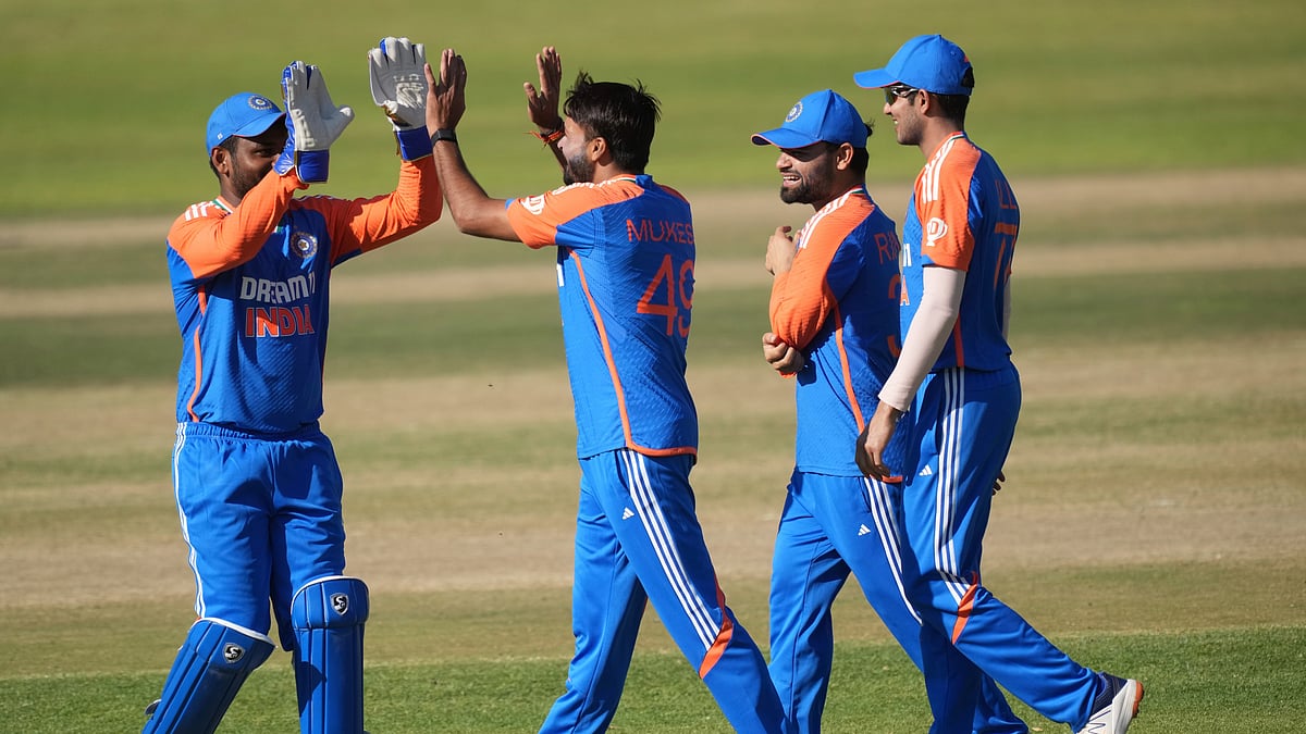 AP Photo/Tsvangirayi Mukwazhi : Indian players celebrate a wicket during the T20 cricket match between Zimbabwe and India at the Harare Sports Club, in Harare.