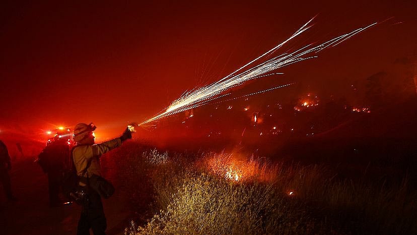 X : Firefighters trying to contain Park fire.