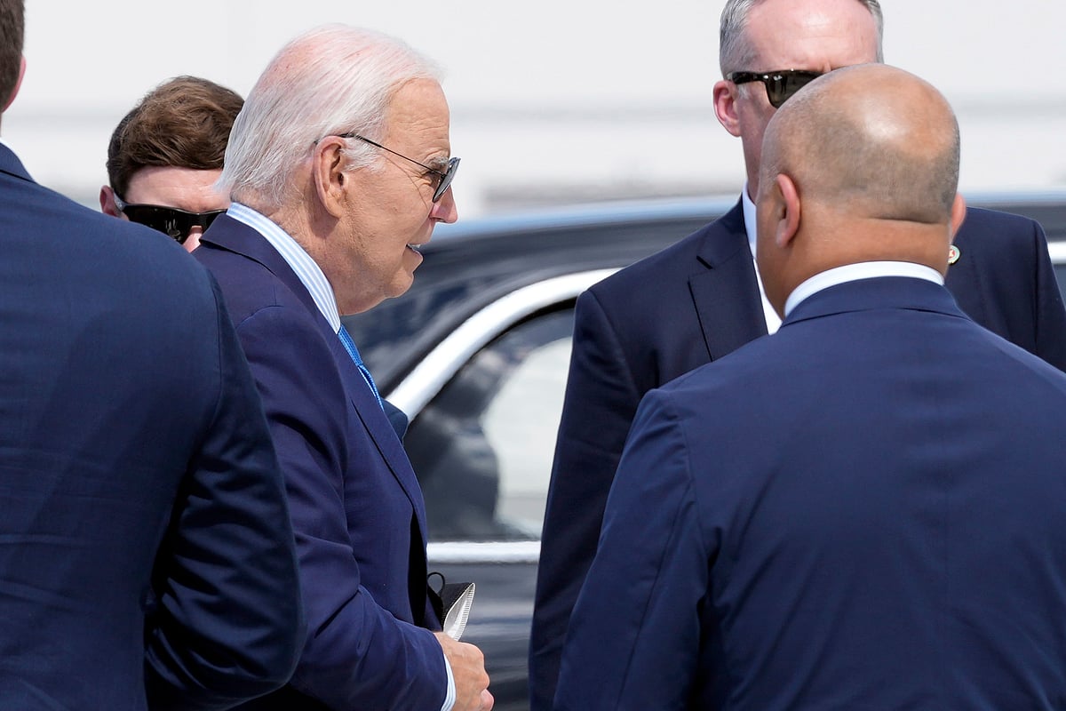 AP : President Joe Biden with a mask in his hand as he walked to board Air Force One | 