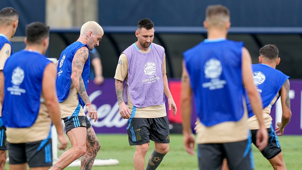 Argentina's Lionel Messi, center, and Rodrigo De Paul, left, do drills as they train for the Copa America soccer final Saturday, July 13, 2024, in Miami. Argentina plays Colombia in the final Sunday. - AP/Lynne Sladky