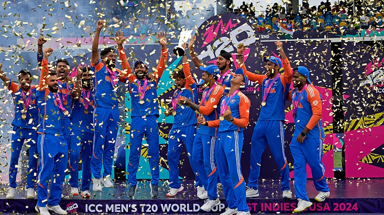 India's players celebrate with the winners' trophy after winning against South Africa in the ICC Men's T20 World Cup final cricket match at Kensington Oval in Bridgetown, Barbados. - AP Photo/Ramon Espinosa