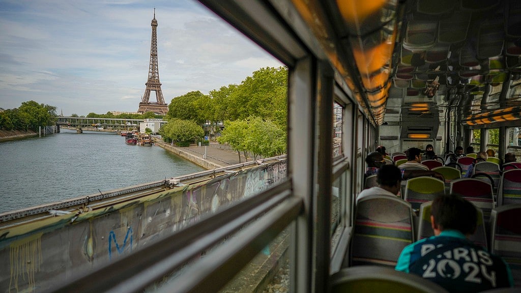 The Eiffel Tower is seen through the window of a commuter train ahead of the 2024 Paris Olympics. - AP/Andrew Medichini