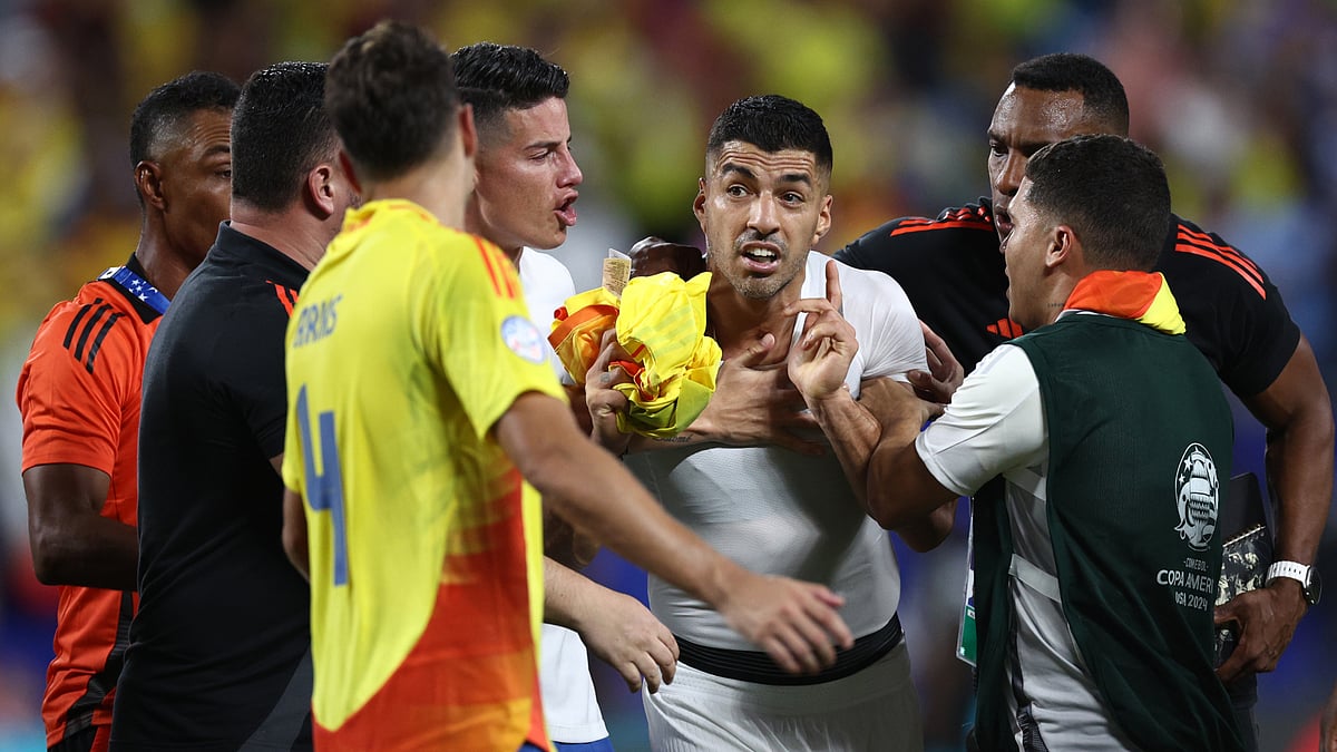 Luis Suarez confronts Colombia's players after Wednesday's semi-final