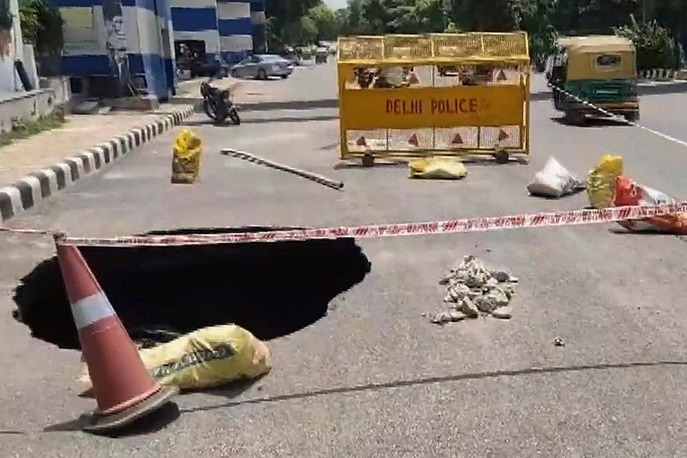 Road caved in Aurobindo Marg after rain in Delhi