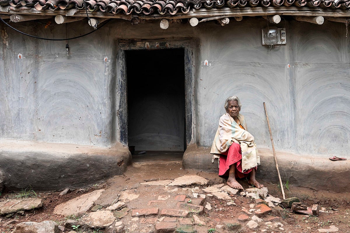 Vikram Sharma : Lakshmi Bedhiya sitting outside her traditional mud house. Residents of Arakeram village have donated more than 70 acres of common land and planted thouasnds of trees over the last 10 years to reforest the hills surrounding their village 