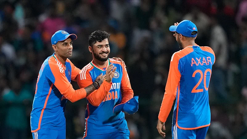 Indias captain Suryakumar Yadav congratulates bowler Riyan Parag. AP Photo