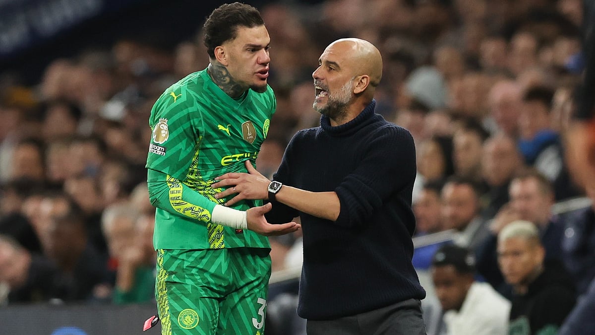 Pep Guardiola and Ederson. - null