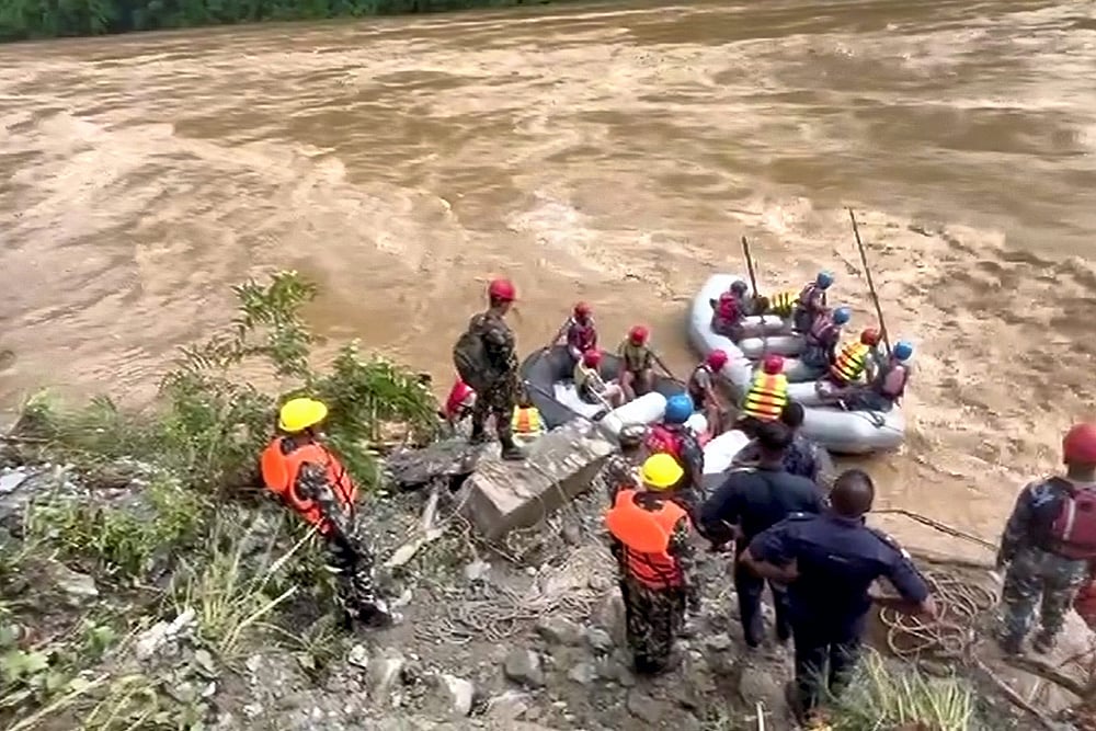 Nepali Army troops during a rescue operation after buses swept away due to landslide in Nepal photo gallery_5