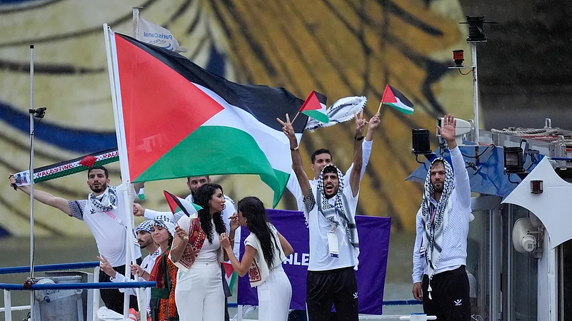 The boat carrying team Palestine makes its way down the Seine in Paris