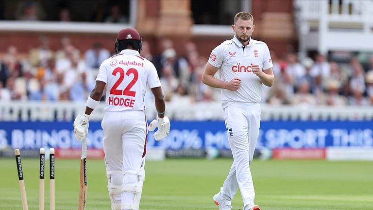 England's Gus Atkinson, right, after taking the wicket of West Indies' Kavem Hodge on day two of the first Test match between England and West Indies at Lord's Cricket Ground, London. - Steven Paston/PA via AP