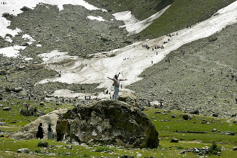 Tourist pose near the glacier in Thajwas area of Sonamarg, Kashmir