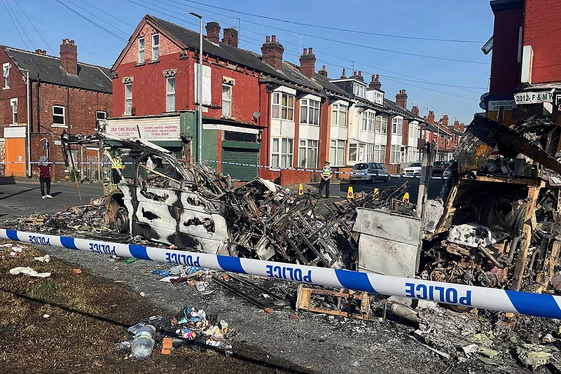 A burnt out car seen after Britain Leeds Riot