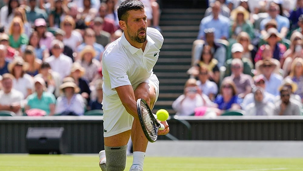 | Photo: AP/Kirsty Wigglesworth : Djokovic plays a forehand return to Jacob Fearnley 