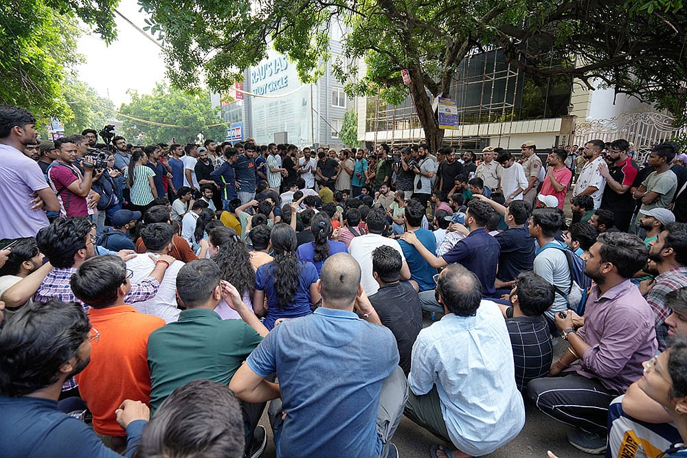 Photo: PTI/Kamal Singh : IAS Coaching Centre basement Flooded in Delhi