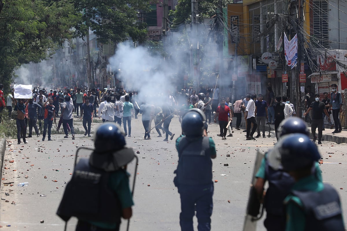 Students clash with riot police during a protest against a quota system for government jobs, in Dhaka - AP