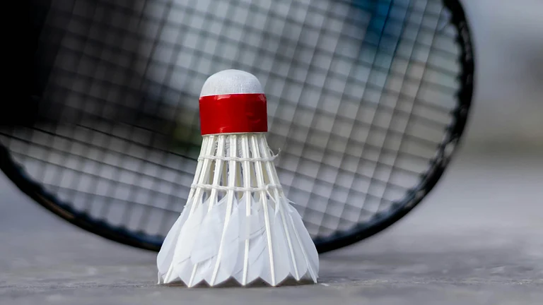 Representative image showing a shuttle and a badminton racket. - Unsplash