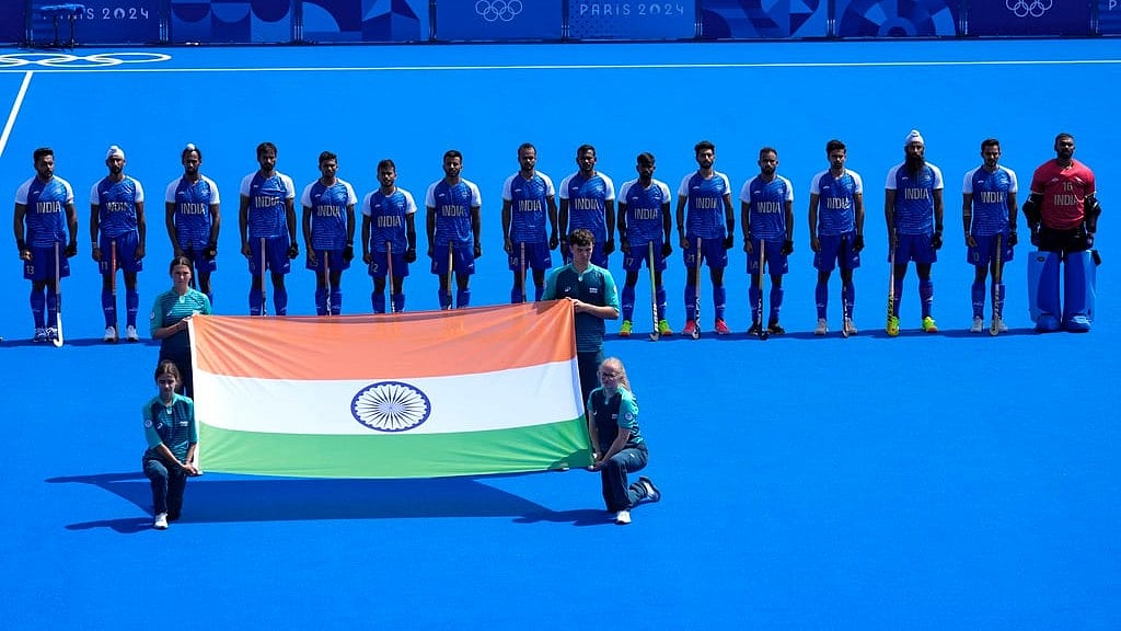 Players of India Hockey team stand for their national anthem before the start of the during the men's Group B field hockey match between Ireland. - AP
