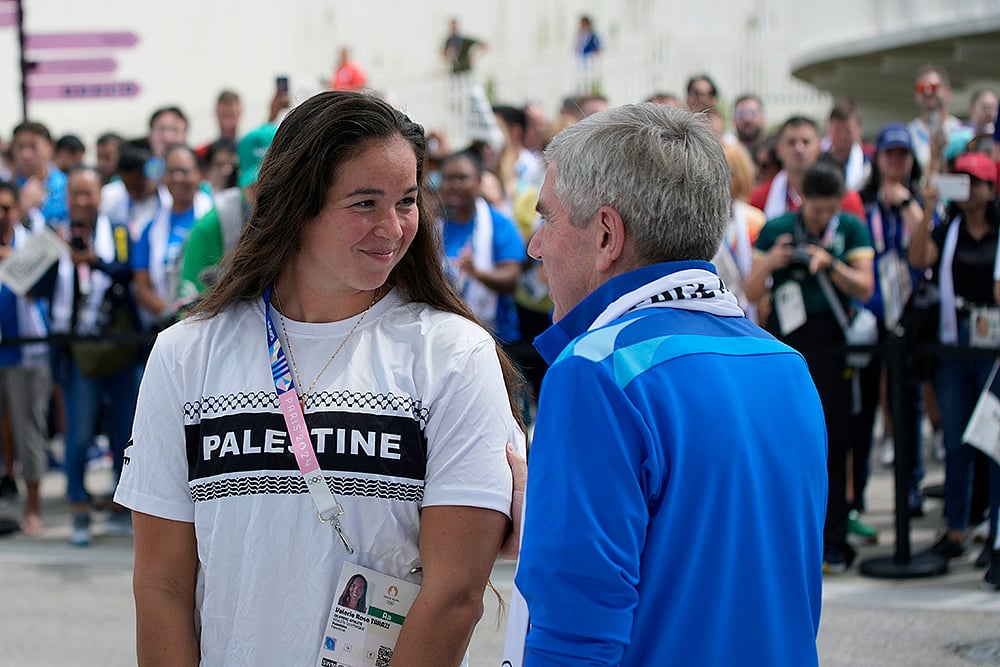 Thomas Bach with Palestinian athlete Valerie Rose Tarazi at 2024 Paris Olympic Village_2