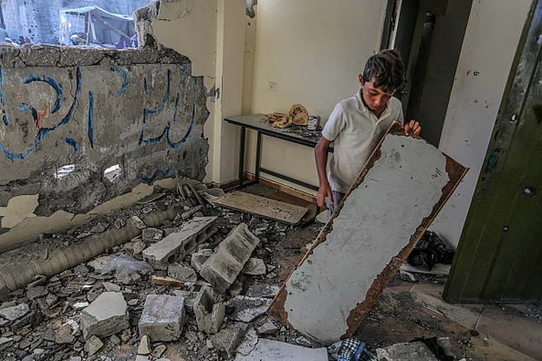 Palestinians investigate the heavily damaged Al-Awda school building following the Israeli attack in Abasan district of Khan Yunis, Gaza on July 10, 2024. - Getty Images