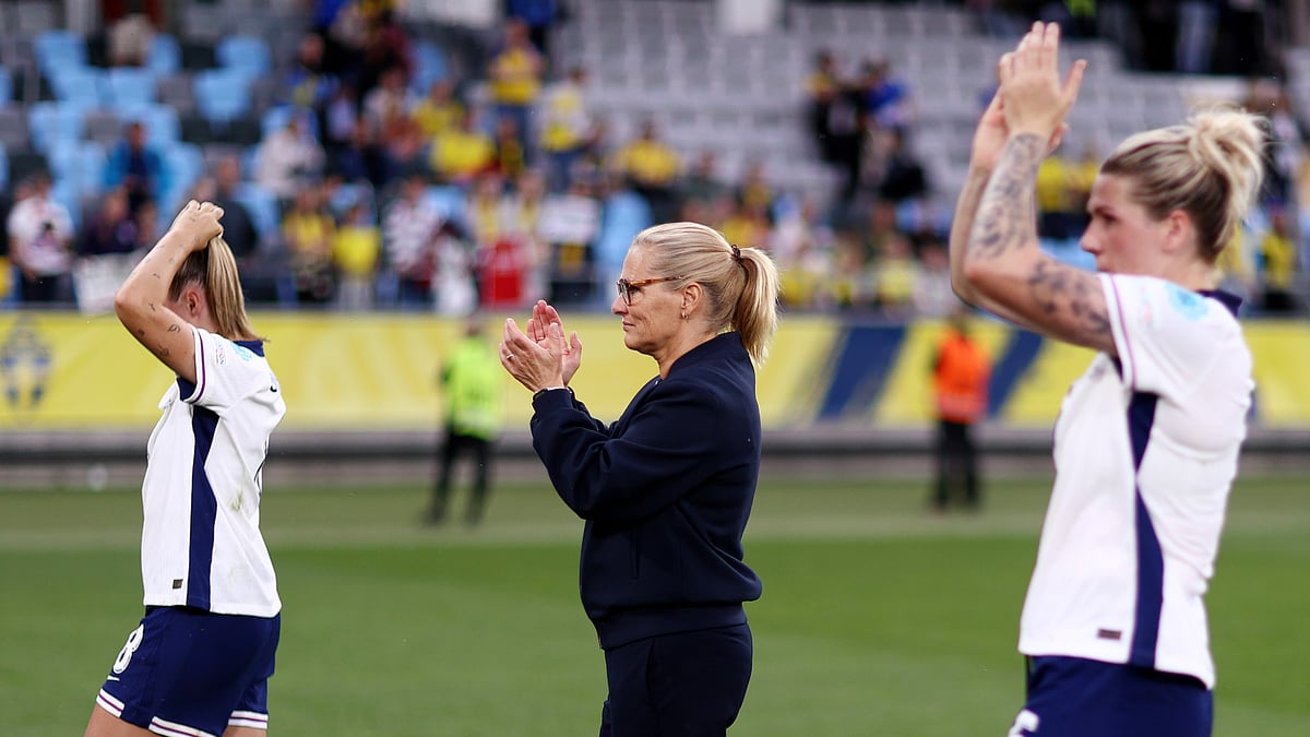 Sarina Wiegman celebrates with England women's players after their Euro 2025 qualification.