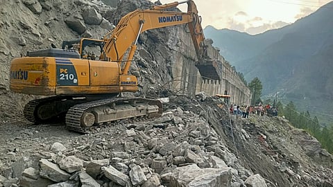 Debris being removed from the road after a landslide near the Patalganga tunnel on the Badrinath National Highway, in Chamoli district, Wednesday, July 10, 2024.