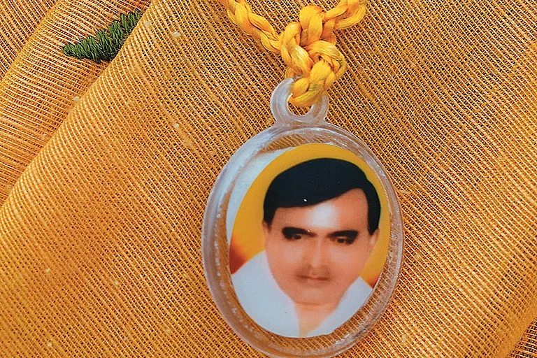 A devotee sports a pendant with Baba Bhole Nath’s face on it in Mainpuri, Uttar Pradesh, sold for Rs 10 each - Photo: Suresh K. Pandey