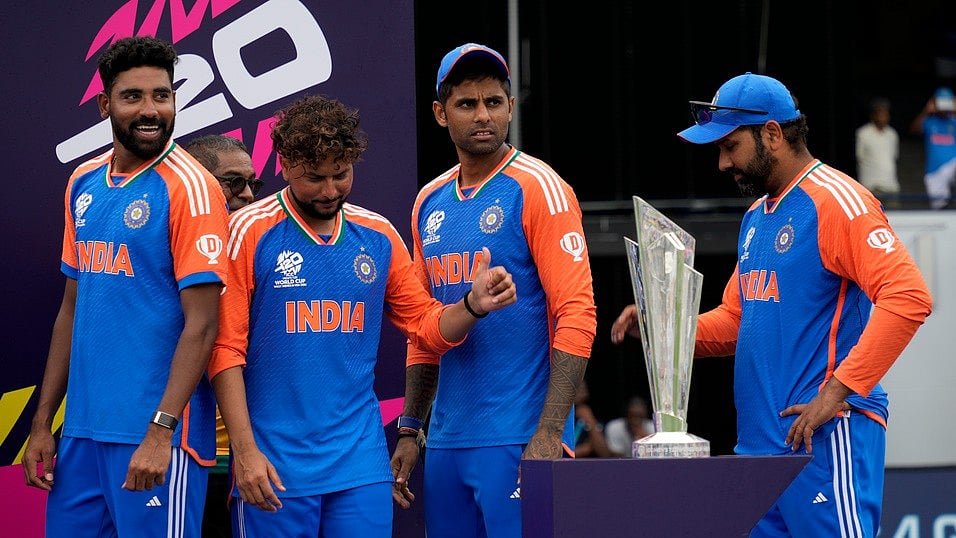 AP/Ramon Espinosa : rom R to L, India's captain Rohit Sharma and teammates Suryakumar Yadav, Kuldeep Yadav and Mohd Siraj stand next to the winners' trophy after winning against South Africa in the ICC Men's T20 World Cup final cricket match at Kensington Oval in Bridgetown, Barbados, Saturday, June 29, 2024.