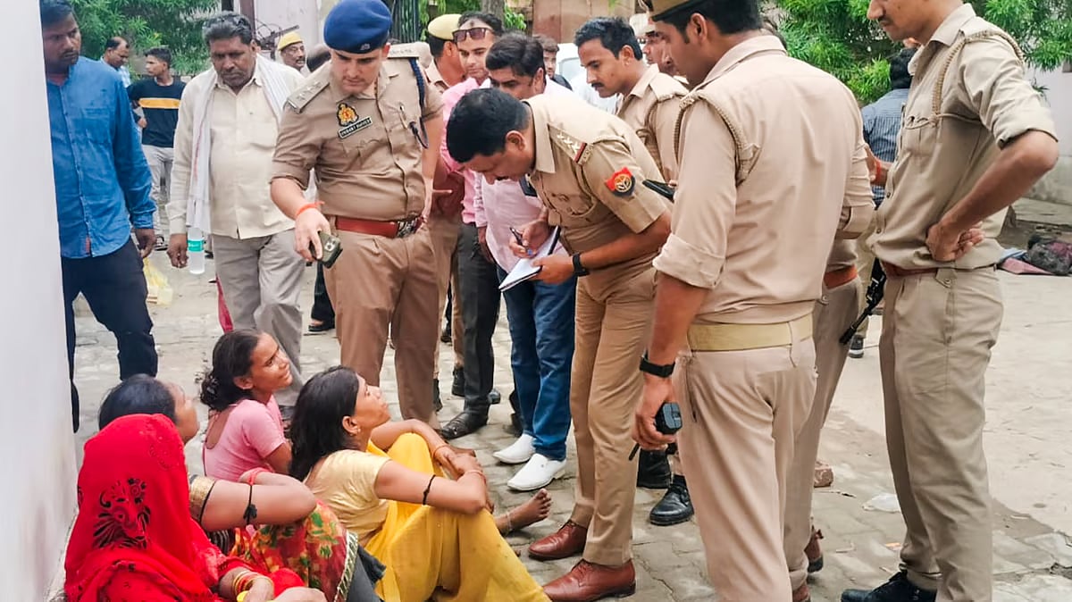 PTI : Police communicating with a Hathras stampede victim's family