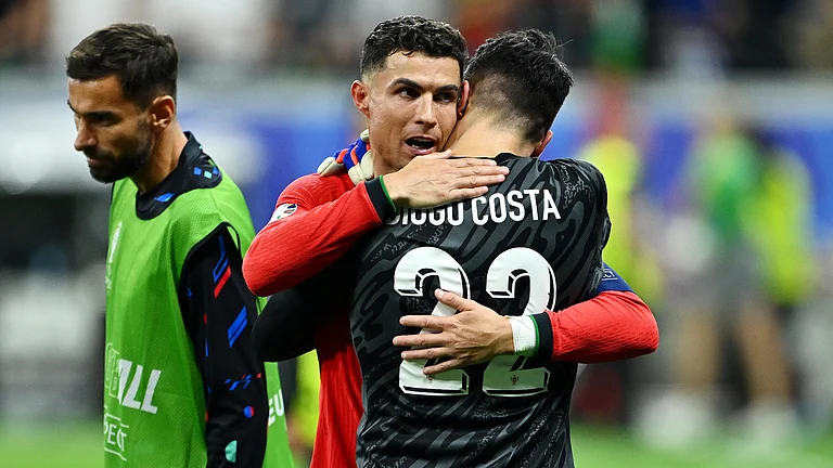 Cristiano Ronaldo congratulates Diogo Costa after Portugal's victory over Slovenia - null