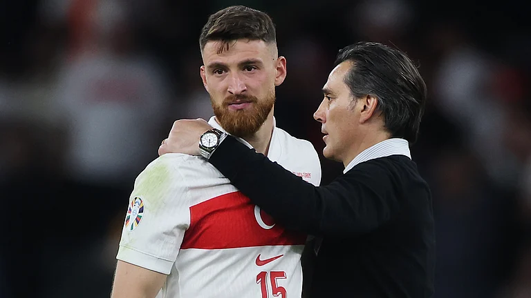 Salih Ozcan is consoled by Vincenzo Montella after Turkiye's defeat - null