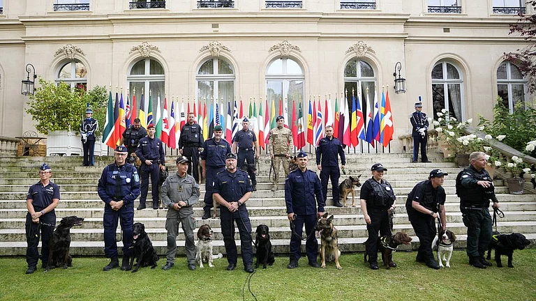 Members of foreign police forces pose for a photo with their dogs in Paris ahead of the 2024 Summer Olympics. - AP