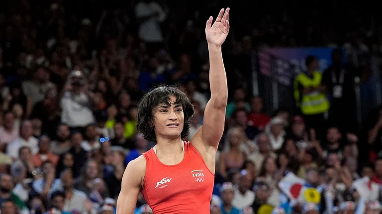 India's Vinesh Vinesh celebrates after defeating Cuba's Yusneylys Guzman during their women's freestyle 50kg wrestling semifinal match, at Champ-de-Mars Arena, during the 2024 Summer Olympics, Tuesday, Aug. 6, 2024, in Paris, France. - AP/Eugene Hoshiko