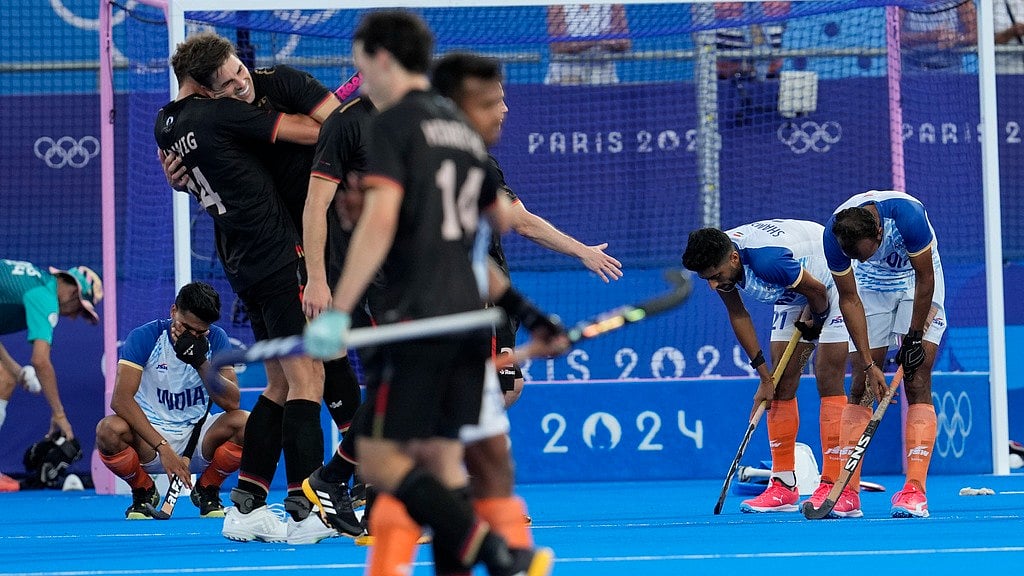 AP/Anjum Naveed : India's player are dejected as Germany's players celebrate their win in the men's semifinal field hockey match against India at the Yves-du-Manoir Stadium during the 2024 Summer Olympics, Tuesday, Aug. 6, 2024, in Colombes, France.