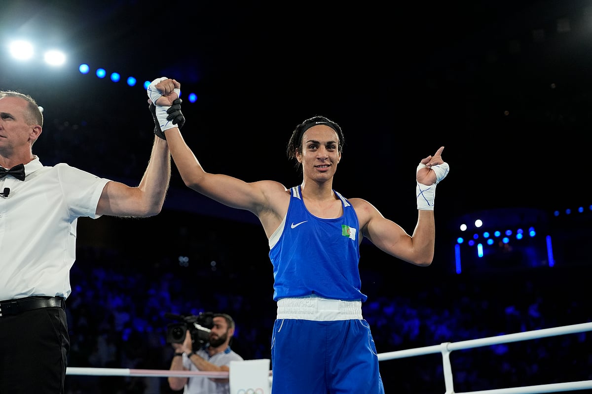  (AP Photo/John Locher) : Algeria's Imane Khelif celebrates after defeating Thailand's Janjaem Suwannapheng in their women's 66 kg semifinal boxing match at the 2024 Summer Olympics, Tuesday, Aug. 6, 2024, in Paris, France.