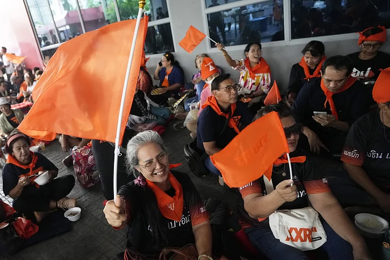 Supporters of Move Forward Party wave the partys flag at the party headquarters in Bangkok |