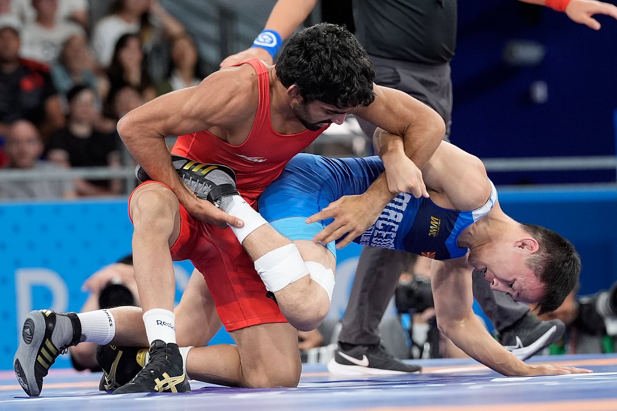 (AP Photo/Eugene Hoshiko) : India's Aman Aman and North Macedonia's Vladimir Egorov, right, compete in the round of 16 of the men's freestyle 57kg wrestling match at Champ-de-Mars Arena, during the 2024 Summer Olympics, Thursday, Aug. 8, 2024, in Paris, France. 
