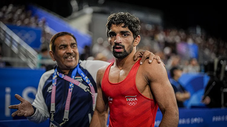 India's Aman Sehrawat (right) reacts after winning the men's freestyle 57kg wrestling quarter-final at the Paris Olympics. - PTI