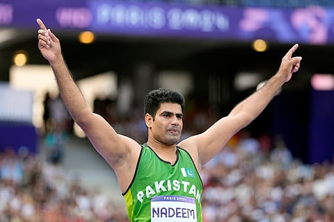 Arshad Nadeem celebrates after breaking the Olympic record in men's javelin throw,