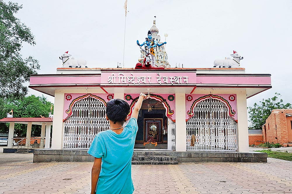 Satish Shinge points at the temple where Dalits are barred