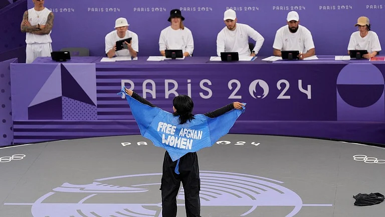 Refugee Team's Manizha Talash, known as Talash, wears a cape which reads "free Afghan women" as she competes during the B-Girls Pre-Qualifier Battle at the breaking competition at La Concorde Urban Park at the 2024 Summer Olympics, Friday, Aug. 9, 2024, in Paris, France. - AP