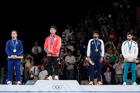 Medalists, from left, Spencer Richard Lee, of the United State, silver, Japan's Rei Higuchi, gold, India's Aman Aman, Uzbekistan's Gulomjon Abdullaev, bronze, stand on the podium during the medal ceremony for men's freestyle 57kg wrestling, at Champ-de-Mars Arena, during the 2024 Summer Olympics, Friday, Aug. 9, 2024, in Paris, France.