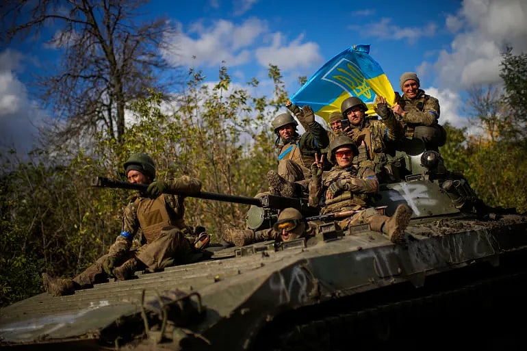 Ukrainian soldiers  on an armoured vehicle | - AP