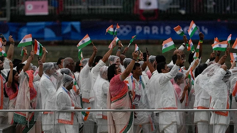Members of Team India wave flags as they travel along the Seine River in Paris, France, during the opening ceremony of the 2024 Summer Olympics. - AP/Anjum Naveed