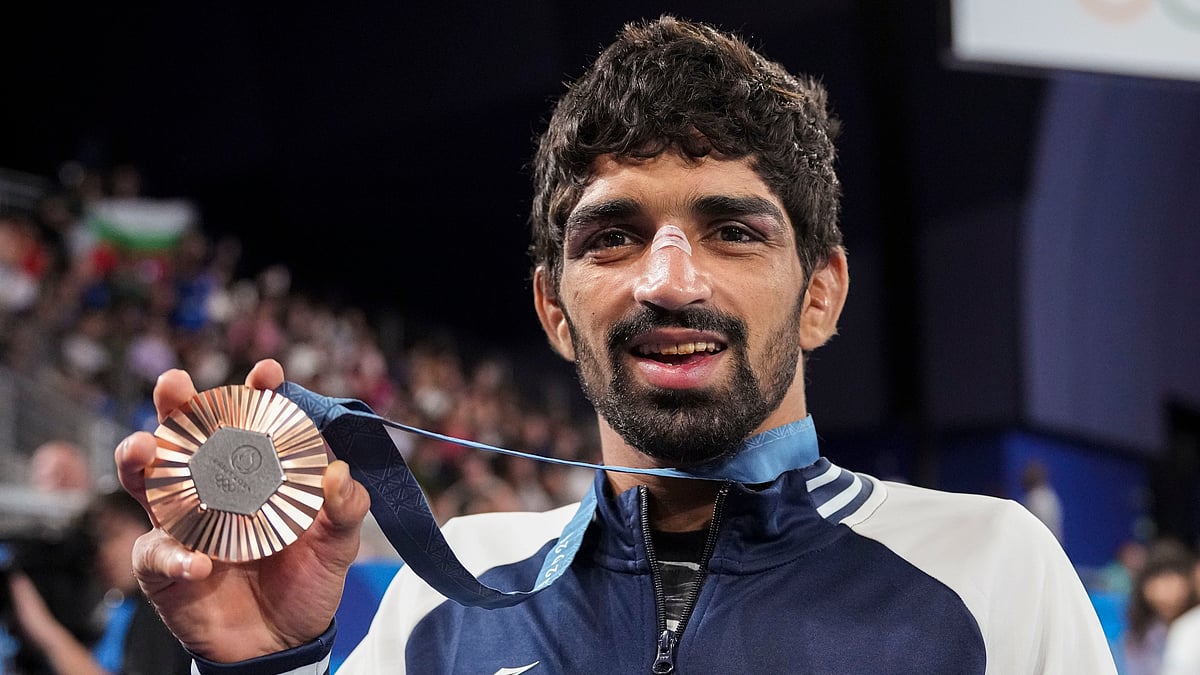 PTI/Ravi Choudhary : Paris: Bronze medalist India's Aman Sehrawat poses for photos at the podium during the victory ceremony for the men's 57kg free-style wrestling event at the 2024 Summer Olympics, in Paris, France, Friday, Aug. 9, 2024. 